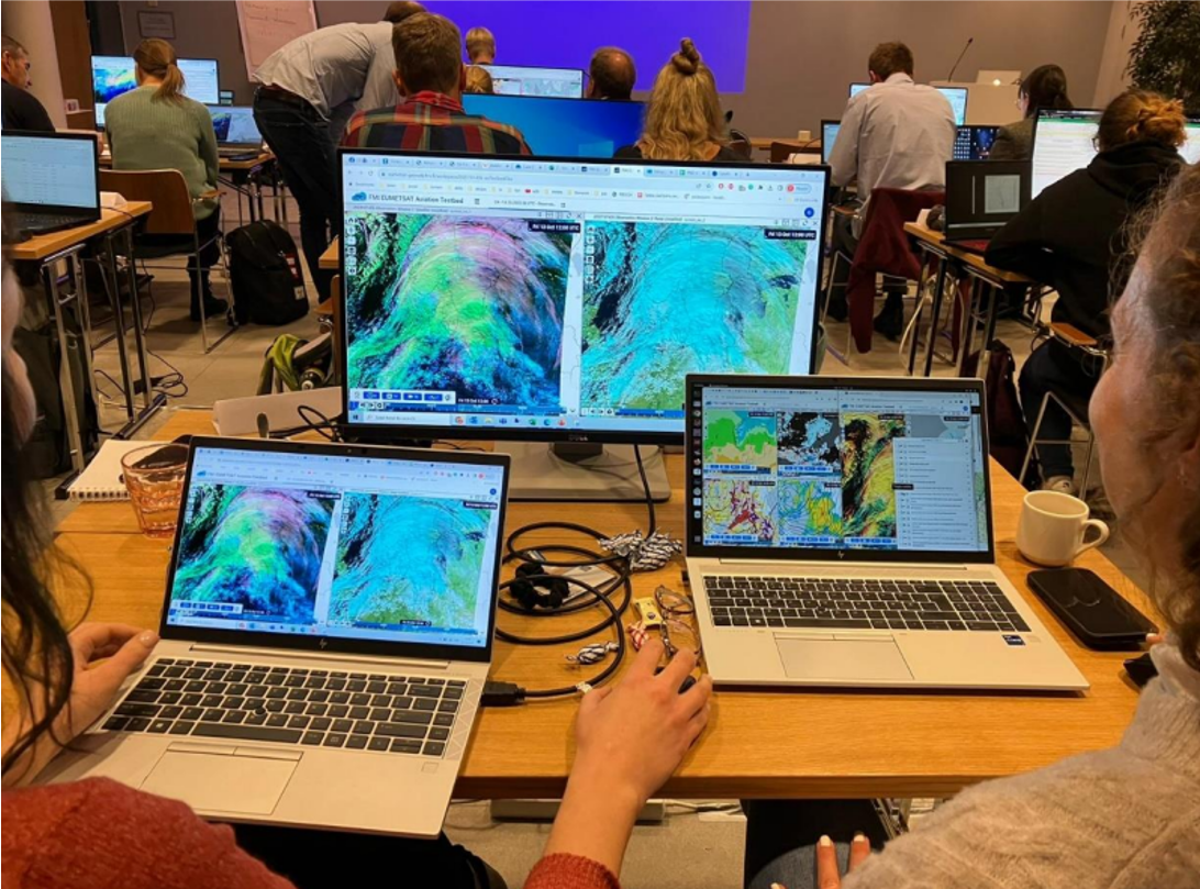 Workshop participants looking at satellite data on laptop computers